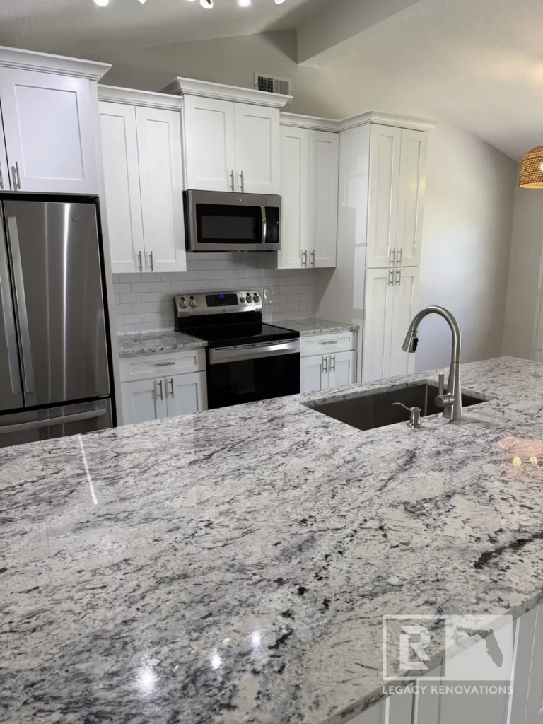 Wide granite island surface with rectangular undermount sink facing full wall cabinetry on Laura Rose Ct.