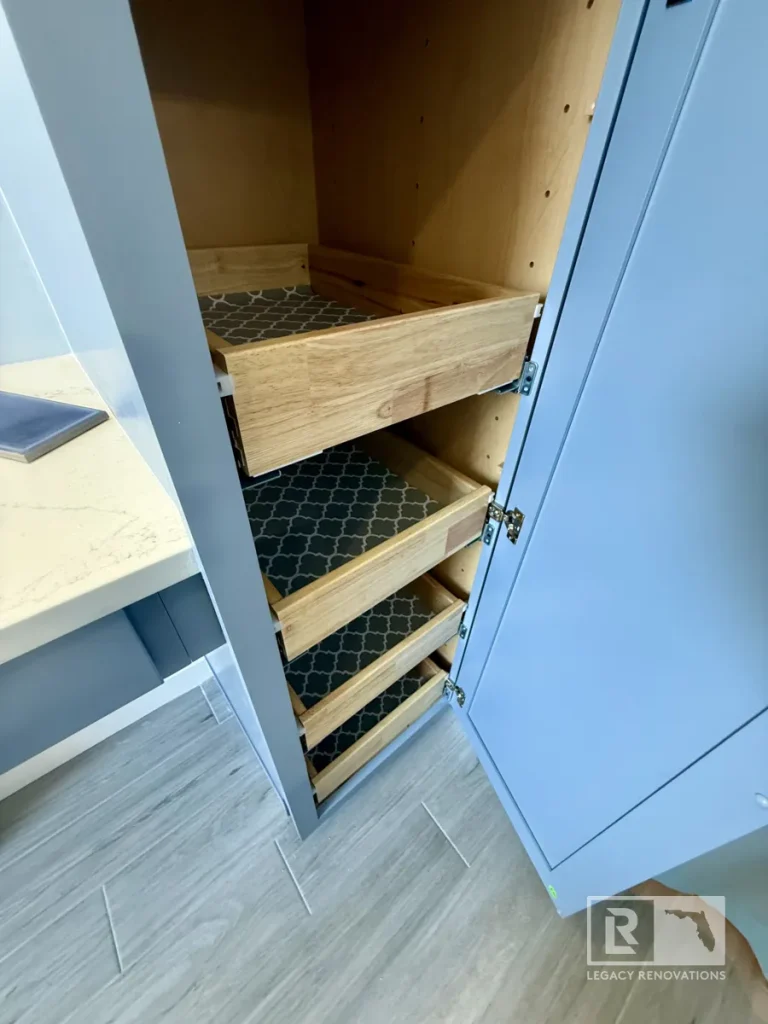 Custom bathroom cabinet featuring pull-out wooden drawers with non-slip liners for organized storage.