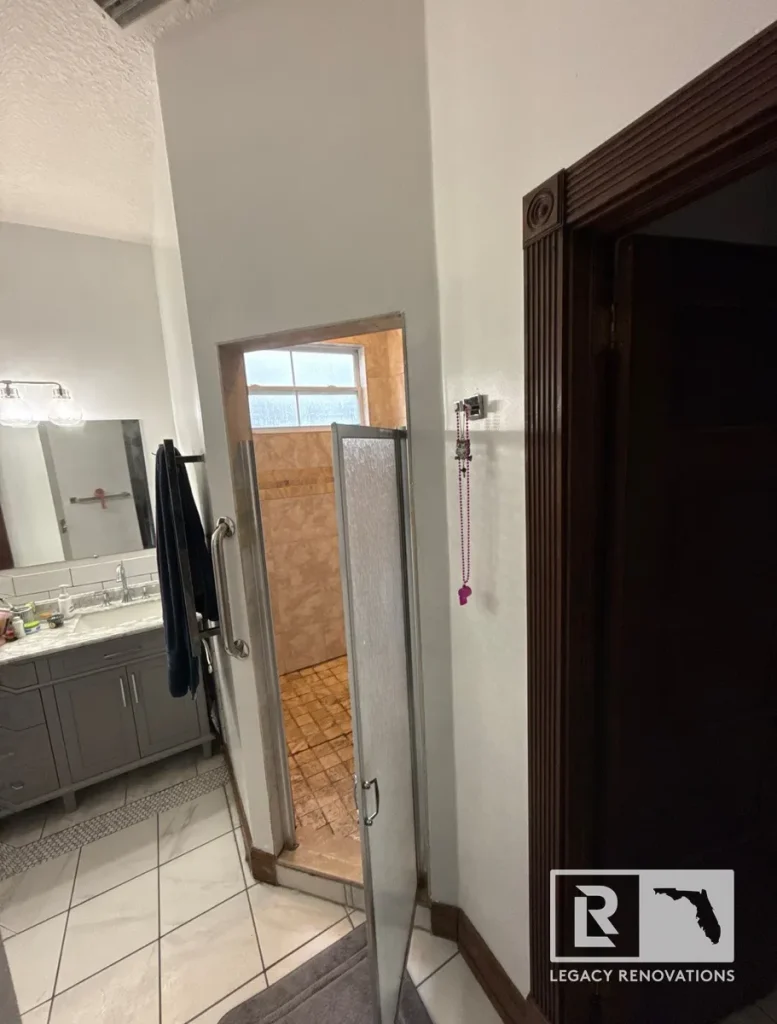 Before bathroom remodel featuring an existing walk-in shower, vanity, and original finishes in Jacksonville, FL.