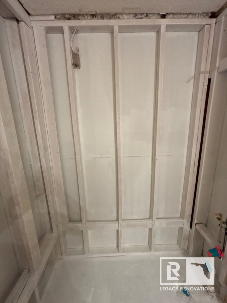 Bathroom shower framing and wall studs prepared for renovation before tile installation in Jacksonville, FL.