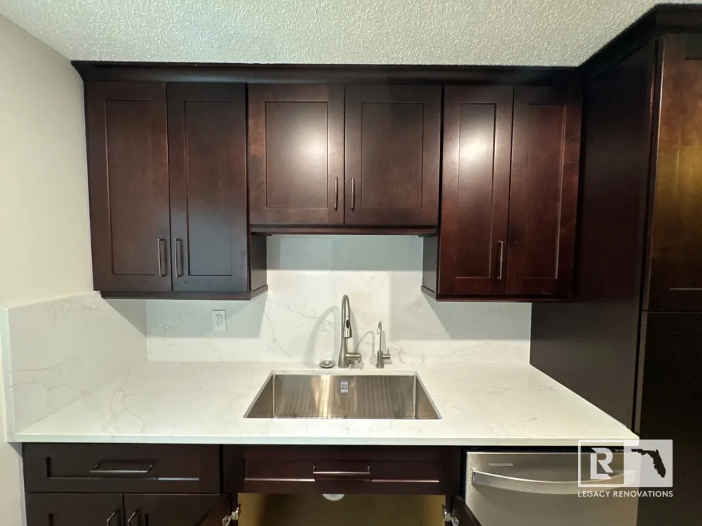 Traditional - Modern kitchen remodel featuring espresso shaker cabinets, quartz countertops, stainless steel undermount sink, and matching quartz backsplash.